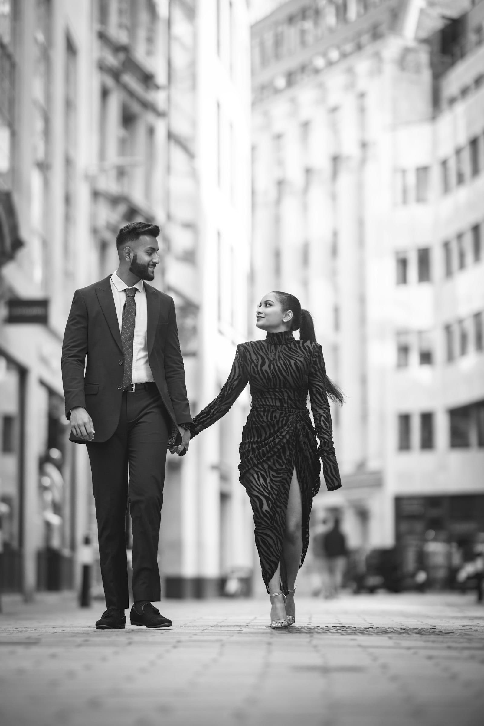 An elegant couple walking hand in hand through the city